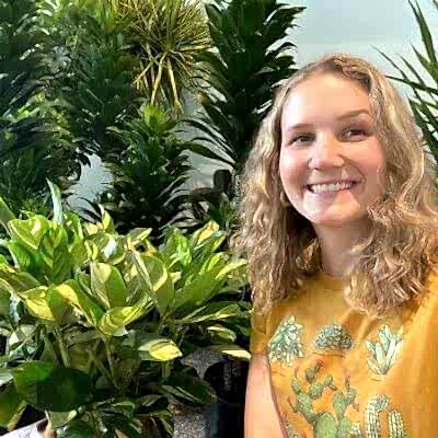 Woman standing next to Bloomscape plants